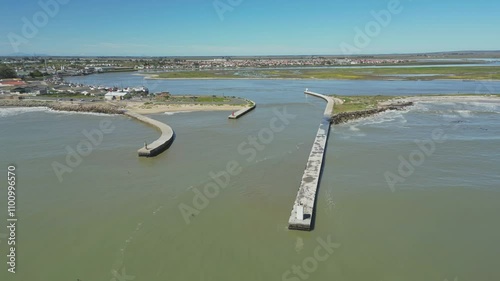 The Berg River mouth in Velddrif with concrete piers reaching into calm waters on a clear sunny day photo