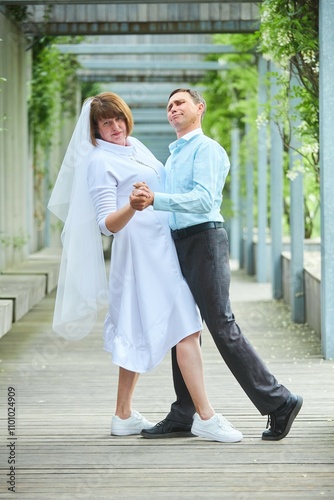 An adult bride and groom. Husband and wife's wedding anniversary photo shoot. We've been together for 30 years.