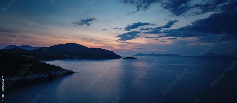 Fototapeta premium Serene twilight over a tranquil sea with dark blue waters and a captivating sky during evening hours
