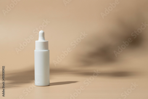 White dropper bottle with pipette at beige background with soft shadow, Abstract minimalist cosmetic beauty product content photo