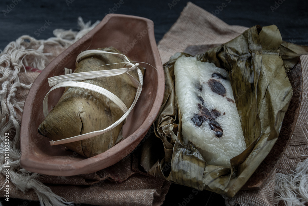 Khao tom mat, a Laotian and Thai dessert of seasoned steamed sticky rice wrapped in banana leaves normally inserted with filling made of banana and black beans for special occasions or merit making.