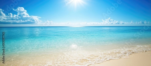 Tranquil sandy beach with clear blue ocean water under a bright sunlit sky inviting relaxation and escape