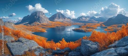 Stunning mountain summit panorama showcasing lakes, rivers, vibrant autumn foliage, and dramatic landscapes under a clear blue sky.