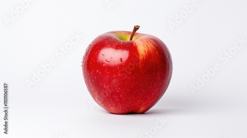 Fresh red apple with water droplets on a minimalist white background showcasing its vibrant color and natural shine.