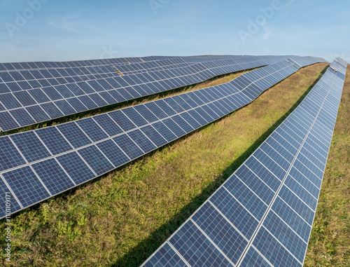 Rows of Photovoltaic Panels. Compose Renewable Energy. Drone Point of View. Solar Power Station Panels. Fields Green Energy at Sunset. Electrical Power Ecology environment. Electrical Innovation photo