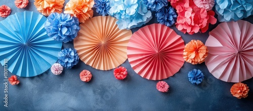 Colorful paper decorations for festive celebrations featuring pom-poms and fans suitable for Independence Day and summer holidays. photo