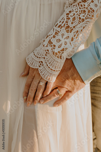 Wedding rings shown off while holding hands photo