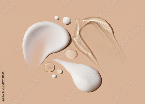 samples of cosmetic care products smear of cream texture on a beige background