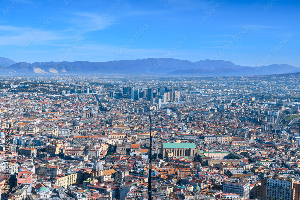 Obraz premium View of Spaccanapoli street splitting city center of Naples. Napoli city skyline with historical Old town, Spaccanapoli street and modern financial district skyscrapers, Italy.