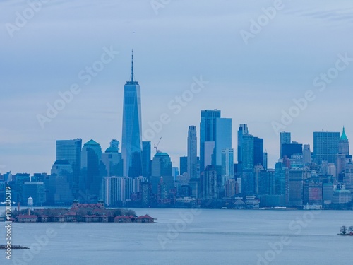 Skyline of New York City against a cloudy sky, viewed from the harbor. photo