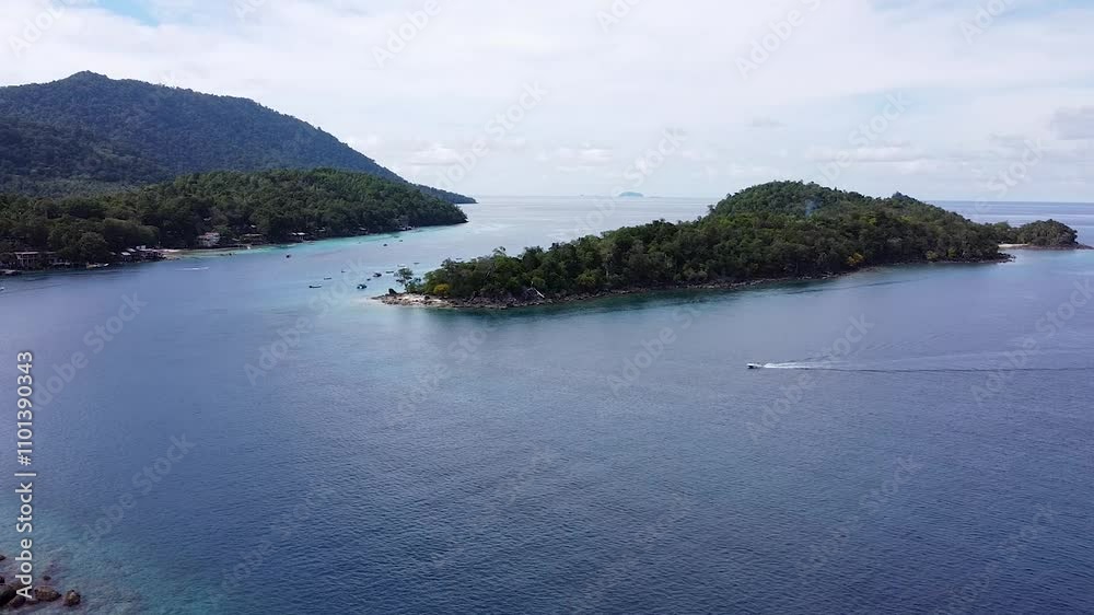 Aerial view of fishing and tour boat returning to Iboih past tropical island of Pulau Rubiah in Pulau Weh Sabang, Sumatra in Indonesia Aerial view of fishing and tour boat returning to Iboih past tropical island of Pulau Rubiah in Pulau Weh Sabang, Sumatra in Indonesia