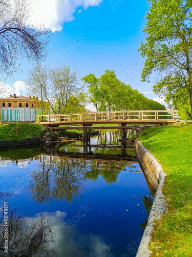 Wooden pedestrian bridge over the channel in city Vyshny Volochyok, Russia photo