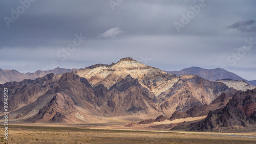 Colorful mountain landscape view in high altitude desert along M41 aka Pamir Highway on overcast day, Murghab, Gorno-Badakhshan, Tajikistan