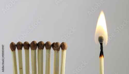 burning match with unlit matches