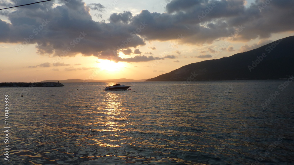 Fototapeta premium Solitary Boat at Sunset: A Quiet Witness to the Day’s Farewell, Reflecting Serenity, Solitude, and the Endless Horizon of Life’s Journey in the Golden Glow of Nature’s Beauty