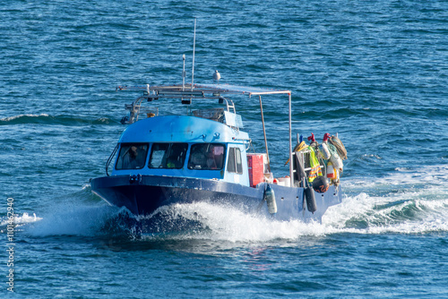 Close-up of a fishing boat sailing in ocean, British Columbia, Canada photo