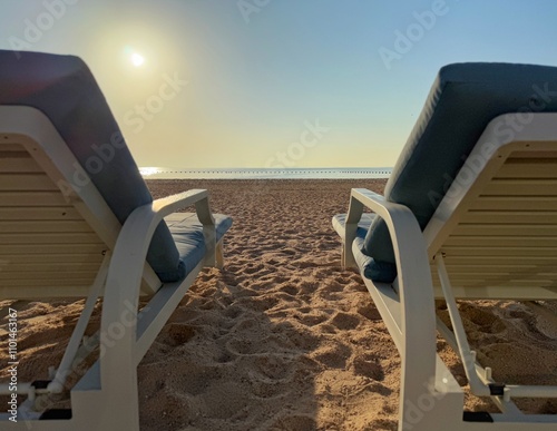 Sea view between two sun loungers on a sandy beach, Qatar photo