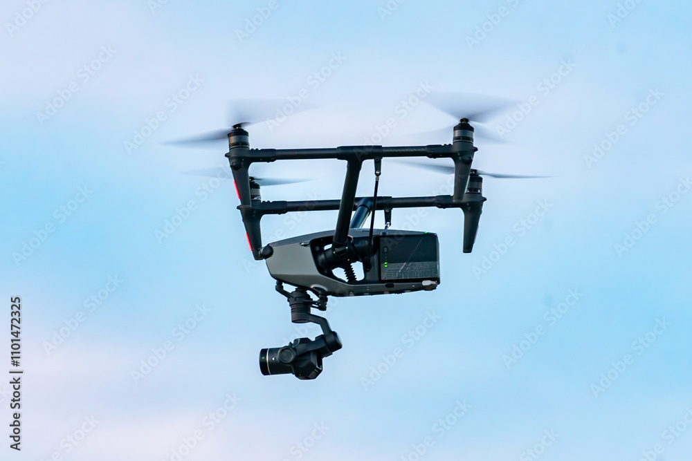 Low angle view of a Drone With Large Video Camera in flight, British Columbia, Canada Low angle view of a Drone With Large Video Camera in flight, British Columbia, Canada