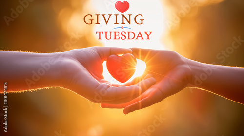 Hands transferring a glowing heart with Giving Tuesday text. photo