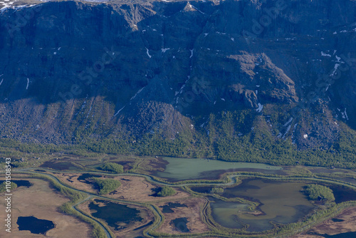 view from skierfe down the valley towards the stream rapaätno in sarek national park
