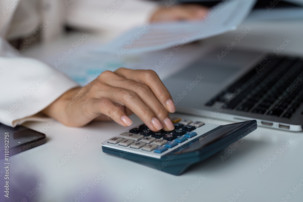 Professional Business Workspace with Laptop, Calculator, and Document for Financial Analysis and Planning Professional Business Workspace with Laptop, Calculator, and Document for Financial Analysis and Planning