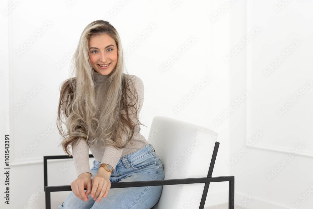 beautiful young caucasian female in comfortable chair indoors	