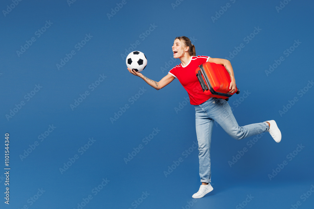 Traveler woman wear red clothes cheer up support football sport team hold passport ticket soccer ball run isolated on plain blue background Tourist travel abroad in free time. Air flight trip concept. Traveler woman wear red clothes cheer up support football sport team hold passport ticket soccer ball run isolated on plain blue background Tourist travel abroad in free time. Air flight trip concept.
