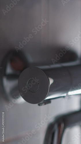 Clean water sprays fall down in shower unit closeup. Turning on hot water to wash body in home bathroom. Modern chrome equipment of washroom photo