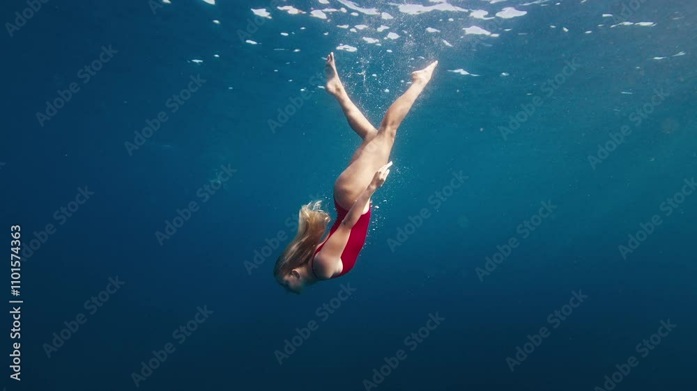 custom made wallpaper toronto digitalTeen girl in red suit dives and swims confidently underwater in the crystal clear tropical sea with sun shining through the water