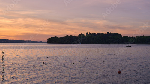 Pier at Sunset with Sailboats, Serene Lake Scene, Orange and Pink Sky, Calm Water, Silhouettes of Boats, Tranquil Evening, Reflections on Water, Peaceful Marina, Dusk Landscape, Nautical Atmosphere