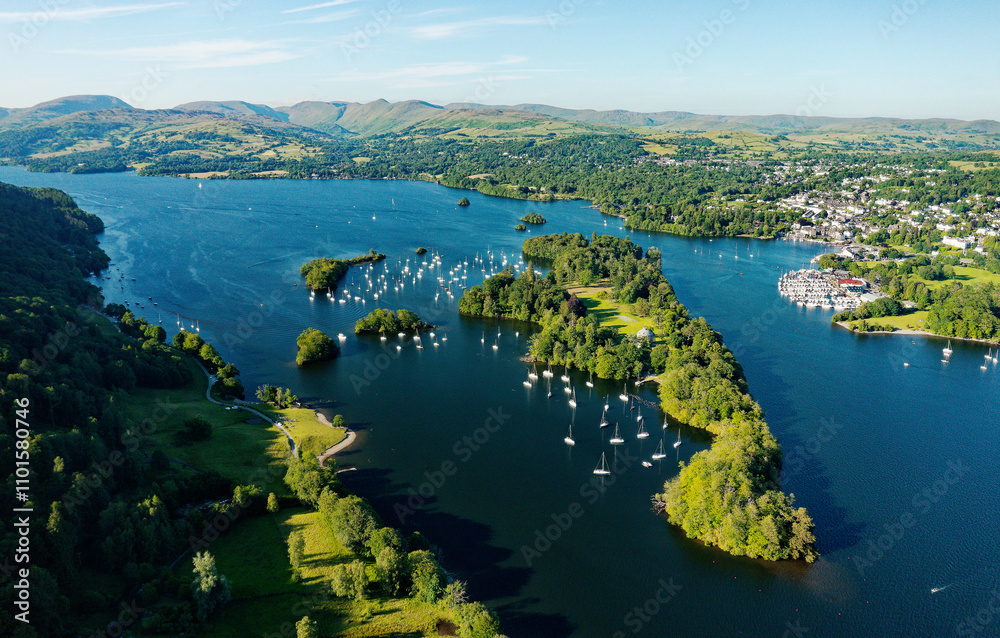 Windermere in the Lake District National Park, Cumbria, England. Aerial vista N.E. over lake centre at Bowness marinas and Belle Isle. Summer evening