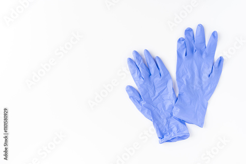Obraz na płótnie Blue latex gloves on white background. Top view w salonie
