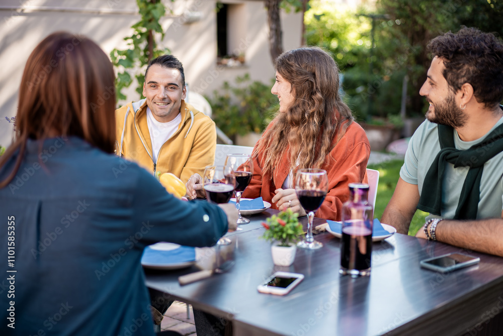 Friends gathering outdoor dining sharing wine conversation authentic lifestyle moment Friends gathering outdoor dining sharing wine conversation authentic lifestyle moment