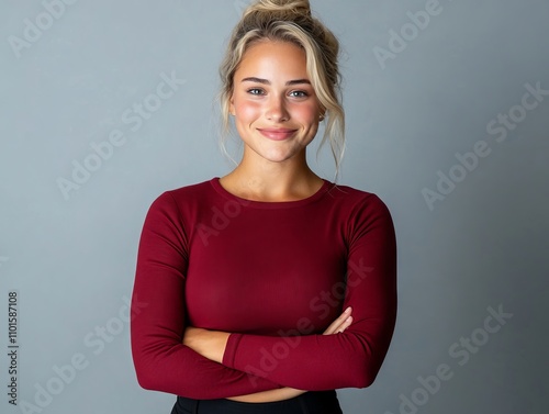 A woman in a red top with her arms crossed