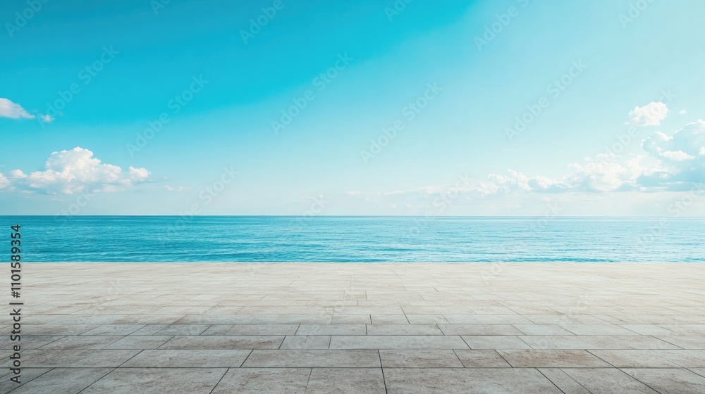 Fototapeta premium Serene ocean view under a vast blue sky with fluffy clouds above an empty concrete surface ideal for promotional banners and tranquil backgrounds.