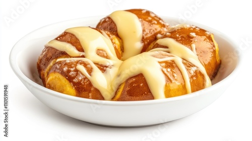 Freshly baked soft pretzel bites drizzled with creamy cheese sauce served in a white bowl on a bright white background