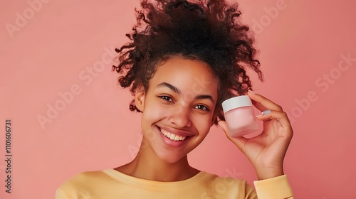 A cheerful person holding up their favorite skincare product