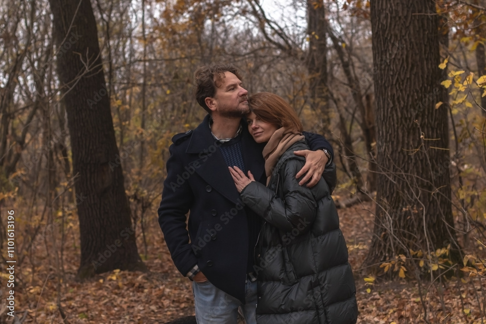 Loving couple walking in autumn park and hugging Loving couple walking in autumn park and hugging