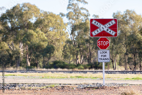 Railway crossing stop look for trains sign photo