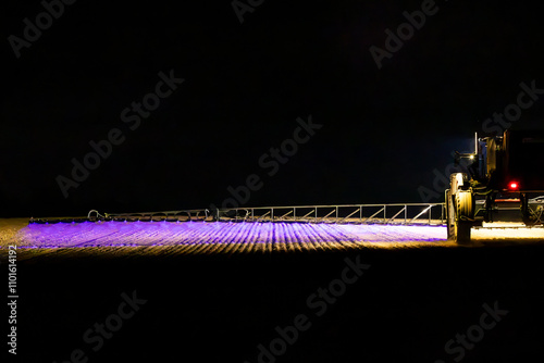 Self propelled boom sprayer spraying herbicide after planting canola