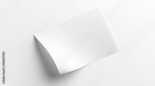 Curved corner blank sheet of white paper resting on a clean white background, viewed from above, showcasing its smooth texture and slight bend.