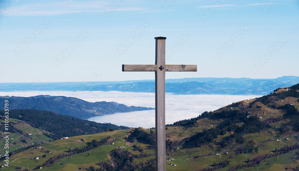 A solitary wooden cross stands tall on a mountain peak, overlooking expansive valleys below, symbolizing faith, reflection, and the vast beauty of the world beneath. A solitary wooden cross stands tall on a mountain peak, overlooking expansive valleys below, symbolizing faith, reflection, and the vast beauty of the world beneath.