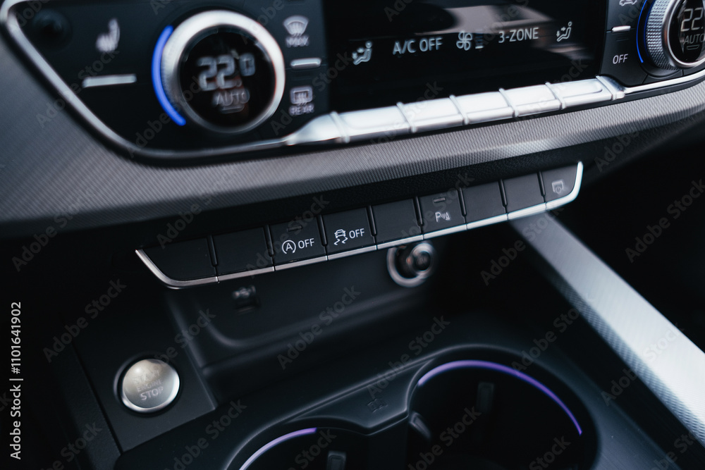 Fototapeta premium Modern brown car interior, leather steering wheel, climate control, navigation, air ducts, deflectors on the car panel, interior details.