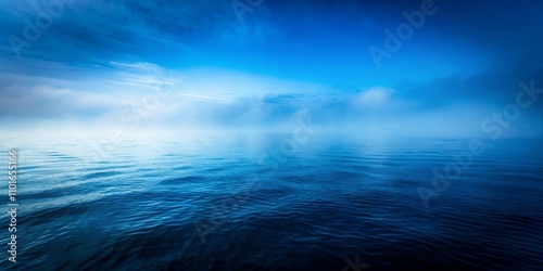 Serene Ocean Mist A tranquil seascape featuring a calm, blue ocean under a hazy, blue sky