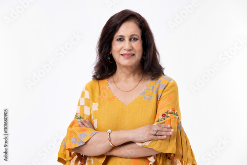 Portrait of confident mature woman wearing formalwear with arms crossed standing against white background photo