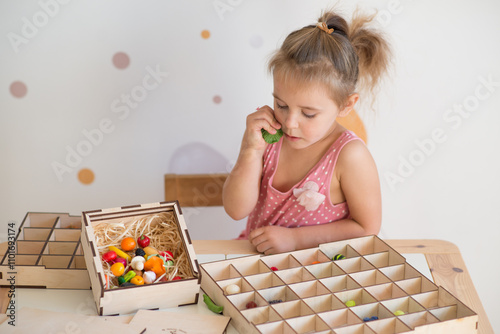 little girl playing sorter at the table photo