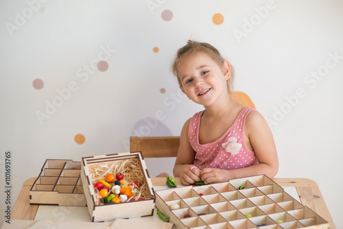 little girl playing sorter at the table photo