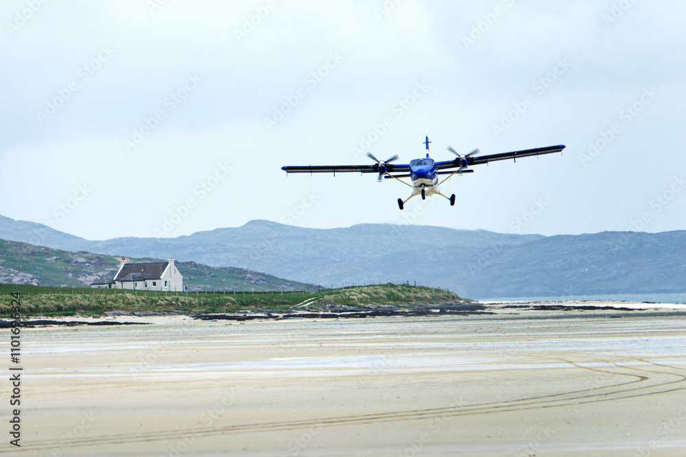 Barra Airport on Traigh Mhor beach at Ardmhor on north end of Barra, Outer Hebrides. Looking NE. Scheduled flight taking off from sands