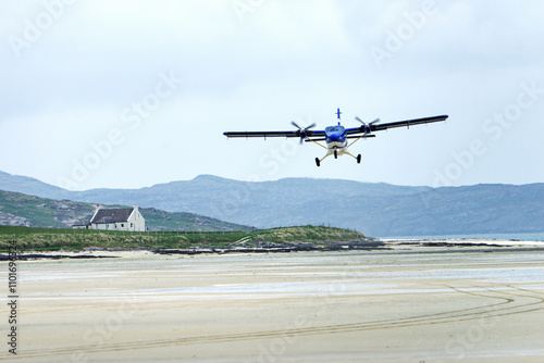 Obraz na płótnie Barra Airport on Traigh Mhor beach at Ardmhor on north end of Barra, Outer Hebrides. Looking NE. Scheduled flight taking off from sands w salonie