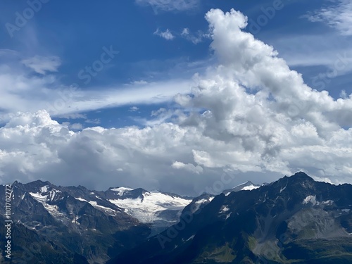 Beautiful photogenic clouds over the Uri Alps massif in the Swiss Alps, Melchtal - Canton of Obwald, Switzerland (Kanton Obwalden, Schweiz) photo